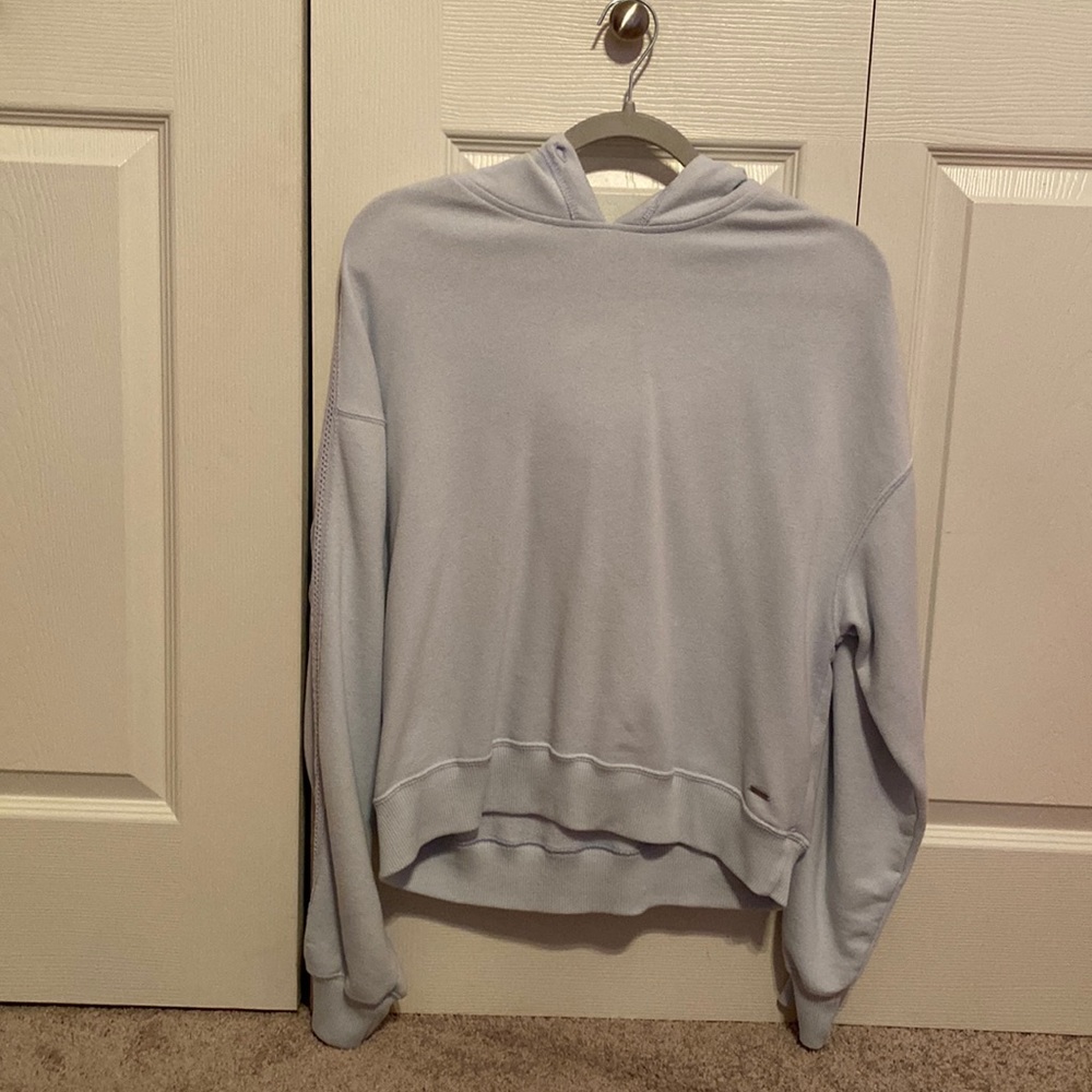 this is a light blue sort of cropped sweatshirt from hollister